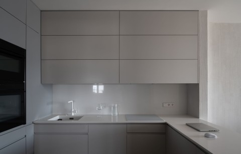 Dining view in Belgrade Waterfront Apartment with muted white walls and black-framed windows