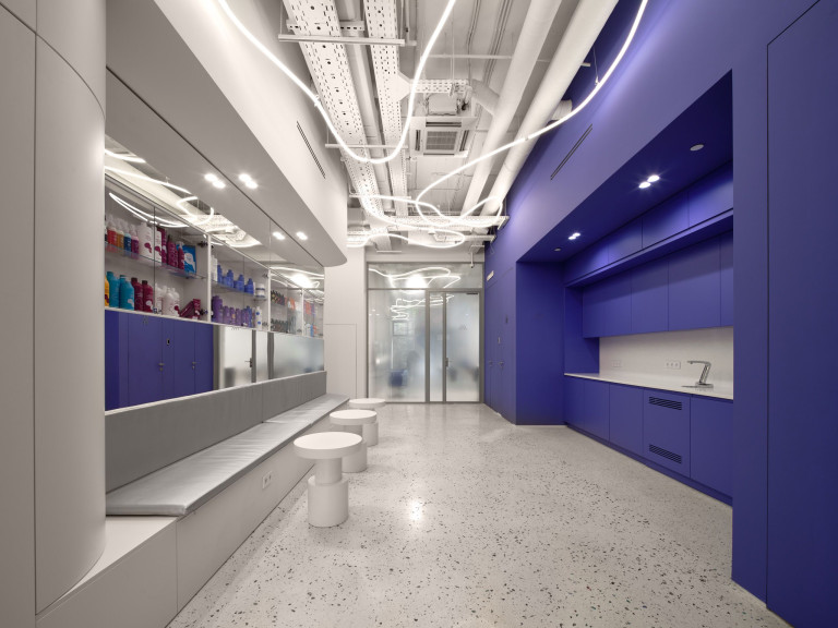 BIG Laboratory interior with glossy metal, mirrored surfaces and bold color accents