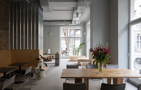 Brutalist interior details and metal wall panels at Chernyi Cooperative Coffee Roasters