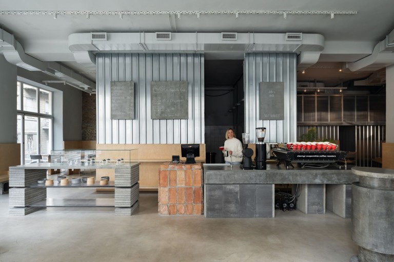Chernyi Cooperative Coffee Roasters bar interior with brick counter and concrete coffee bar