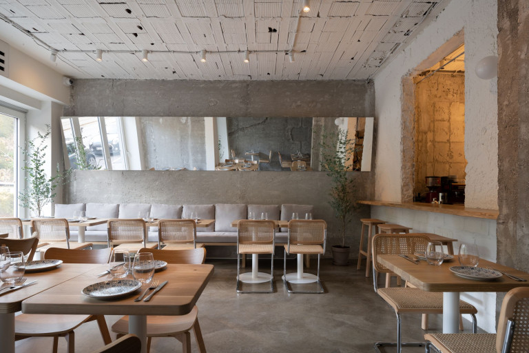 Embers Restaurant dining room with reclaimed brick, concrete textures and warm light