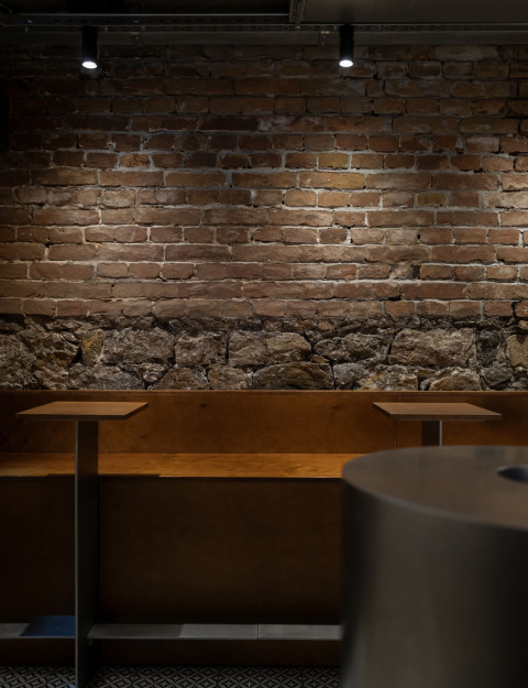 Vertical view of Fresca Cellar with wine display, stone walls and intimate lighting