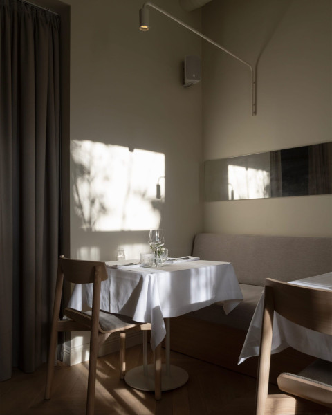 Fresca Restaurant dining room with creamy walls, vintage chandelier and soft historic atmosphere