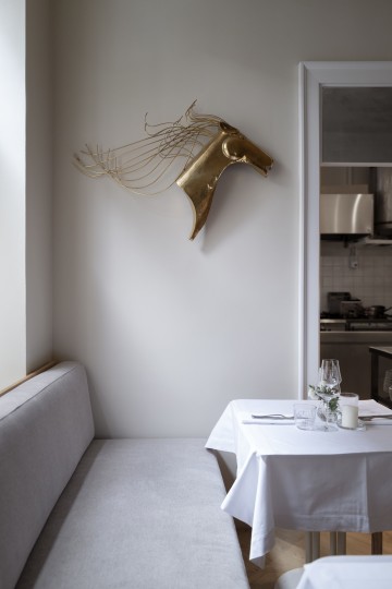 Vertical preview of Fresca Restaurant with warm lighting, table setting and beige interior palette