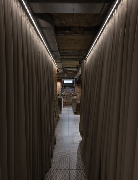 Vertical view of Fresca Deli with brick ceiling, curtains and approachable cafe atmosphere