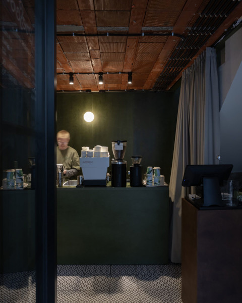 Vertical deli counter and seating area at Fresca Deli with playful material details