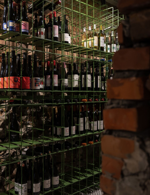 Vertical detail of Fresca Cellar with raw historic surfaces and wine-focused interior