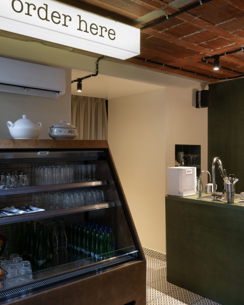 Vertical view of Fresca Deli showing green plywood surfaces and informal hospitality design