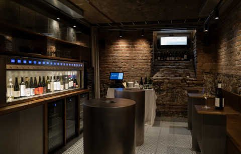 Wide Fresca Cellar interior with preserved foundation stone and wine bar atmosphere