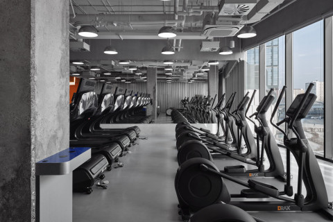 Shower and reset zone at Gate-X Fitness Club with concrete finishes and dramatic lighting