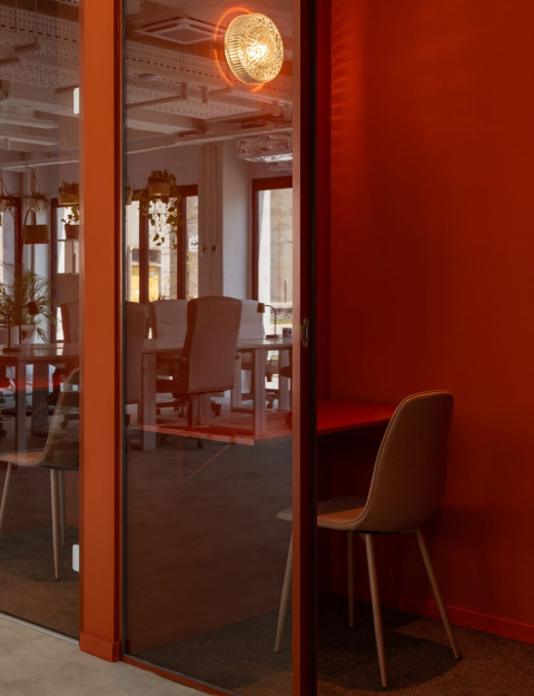 Vertical view of Haos Community Space open area with terracotta details and warm office atmosphere