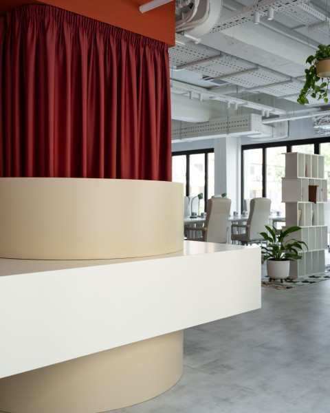 Vertical view of Haos Community Space with warm coworking lounge and terracotta interior elements
