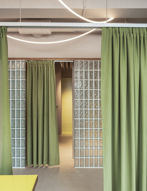 Interior detail with curtain and warm finishes at Loka Yoga & Cafe