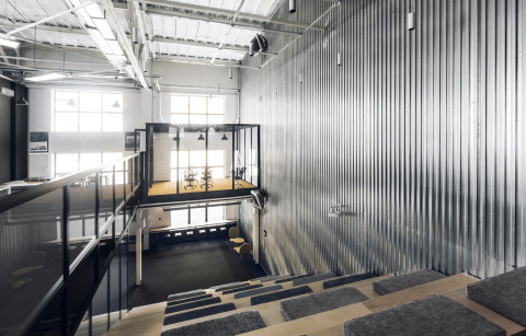 Mighty Buildings office with floating glass meeting room above the industrial workspace