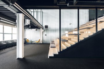 Mighty Buildings office amphitheater stair with industrial metal walls and open workspace