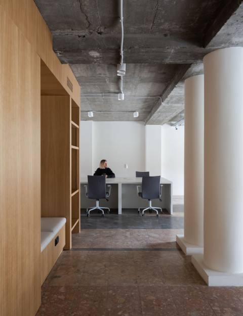 Library and storage zone inside the oak cube at PFU Coworking