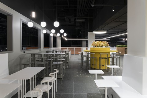Terracotta seating zone and curved interior forms in Siesta Shopping Center