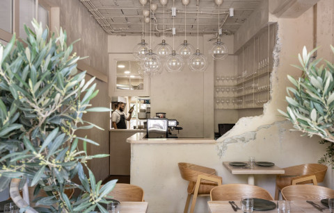 Horizontal view of Stories restaurant bar with stacked block counter and beige interior palette