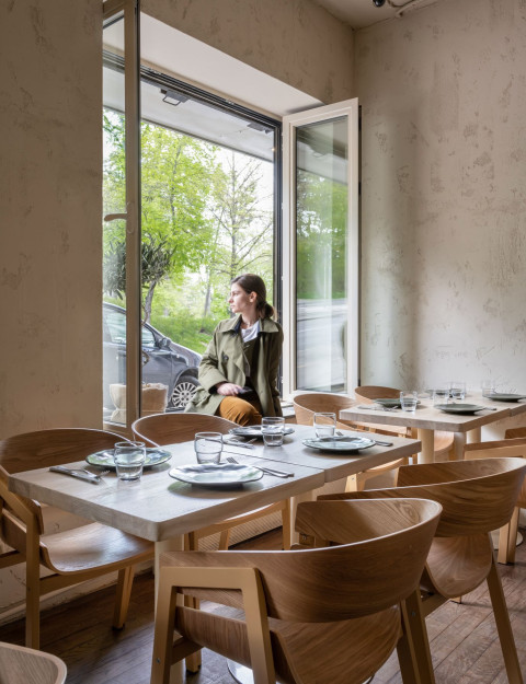 Wooden chair and textured wall detail in Stories restaurant dining area