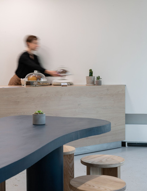 Curved cafe counter and pastry display at The Waterfront Cafe