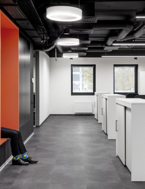 UNICA Office orange window niche beside monochrome workstations