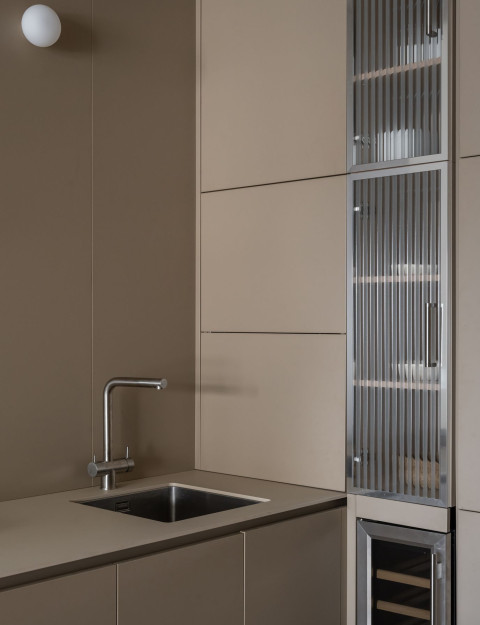 Compact kitchen detail with dark finishes inside Vracar Apartment