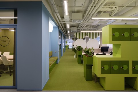 Blue and green office zone with desks at Yandex Office 03