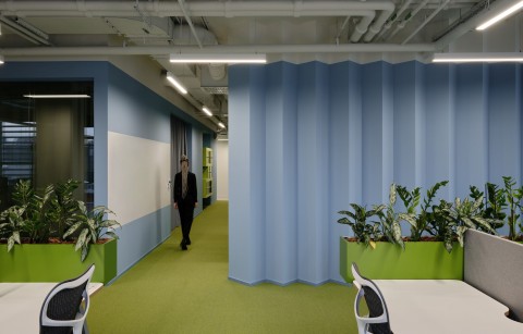 Open-plan office area at Yandex Office 03 with blue and orange accents