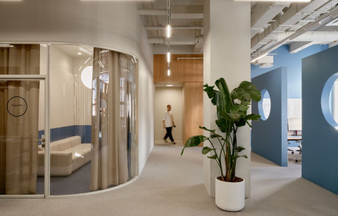 Wide view of blue geometric partitions with circular openings in Yandex Office 02