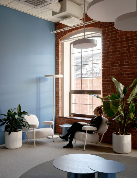 Vertical detail of Yandex Office 02 with natural light, workstations and historical brick texture