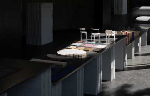Wide process installation showing sketches, prototypes and furniture design choices