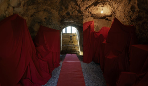 Cemetery of genius ideas installation with covered furniture and red fabric