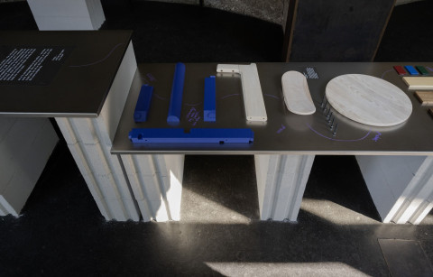 Wide exhibition detail with furniture and installation elements