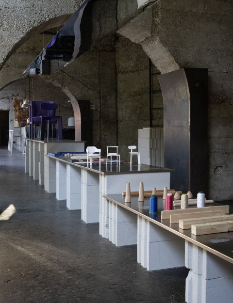 Vertical gallery view with chair exhibition materials and objects